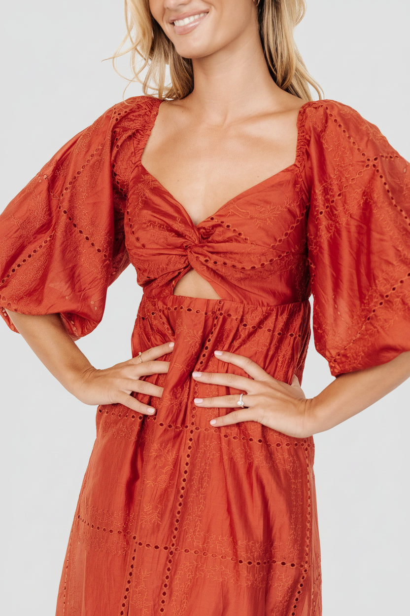 Close-up of Brynn rust fabric showing tonal embroidery, twist bust detail, and the texture of the Tencel-blend material.