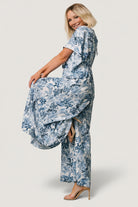 Close-up of rayon fabric and Caribbean deep blue floral print on white background, showing texture and drape