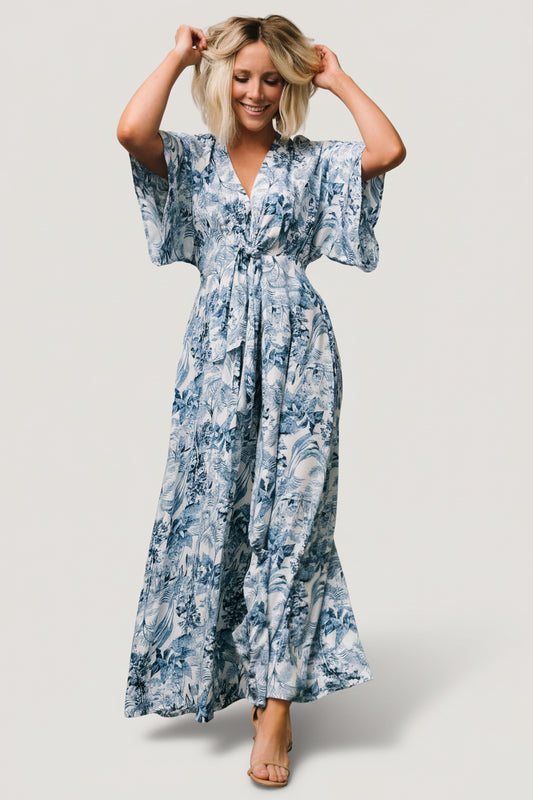 Front view of blue floral Byron jumpsuit with deep V neckline and wide-leg flared pants on mannequin