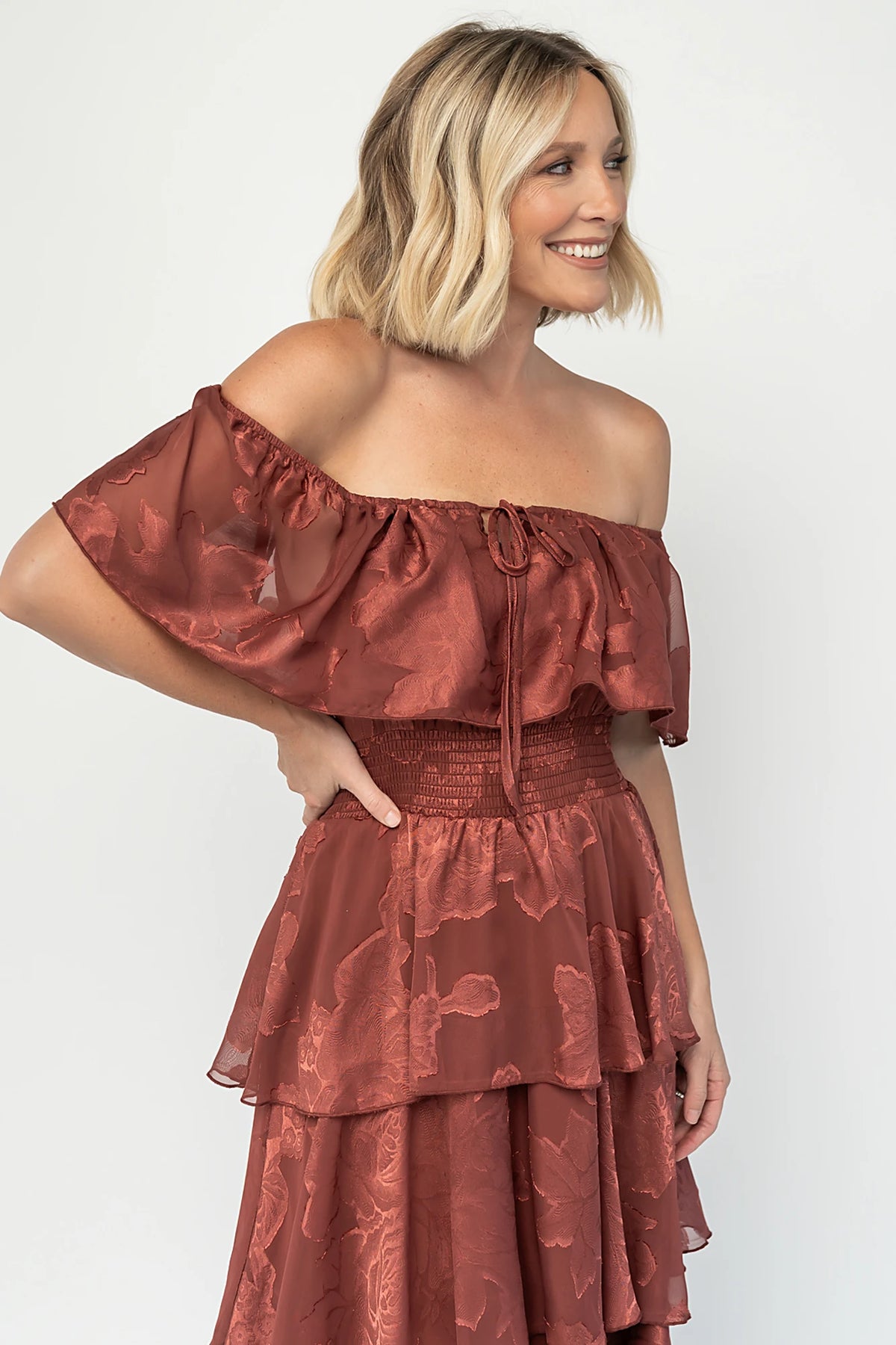 Carina Off Shoulder Maxi Dress in Marsala with ruffle neckline, smocked waist, and four-tiered chiffon skirt.
