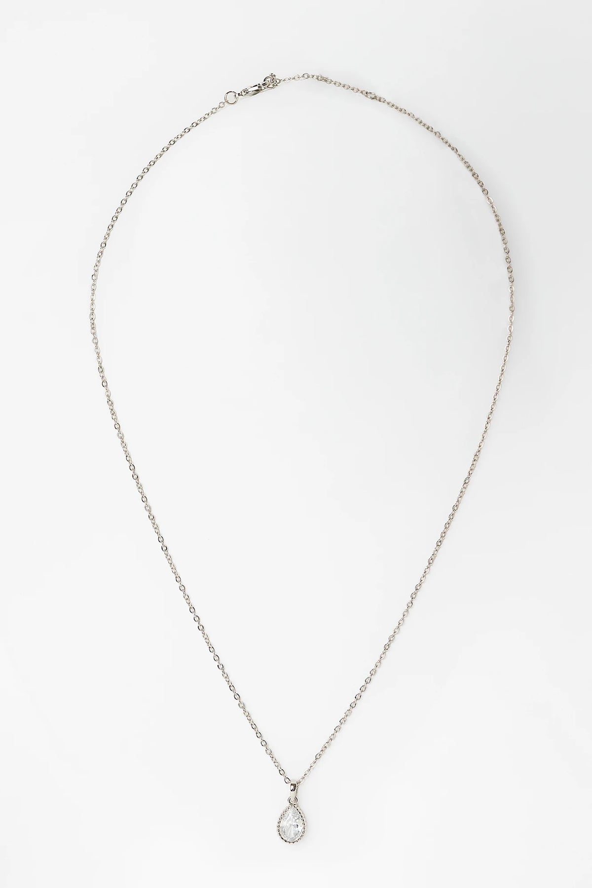 Christy Teardrop Pendant Necklace in Silver with teardrop cubic zirconia pendant and delicate chain.