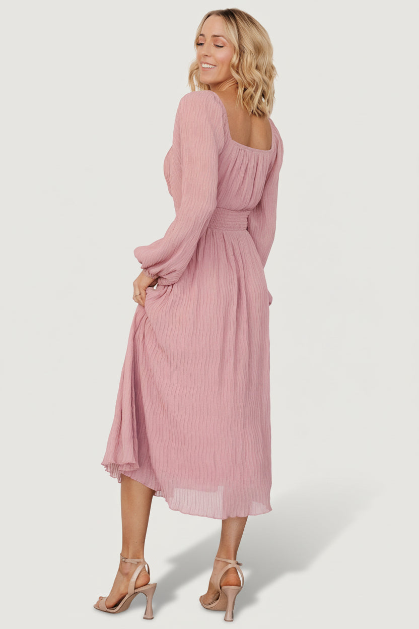 Detail of long balloon sleeve and elastic cuff on the Dalton blush dress, illustrating sleeve volume and construction.