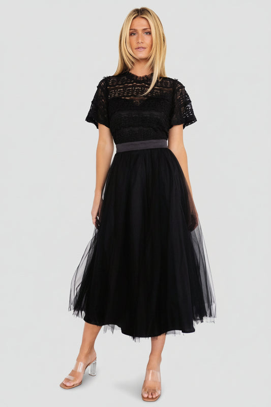 Front view of black tulle midi dress with lace bodice, sweetheart-lined inner, short sleeves, and satin waist tie on a neutral background.