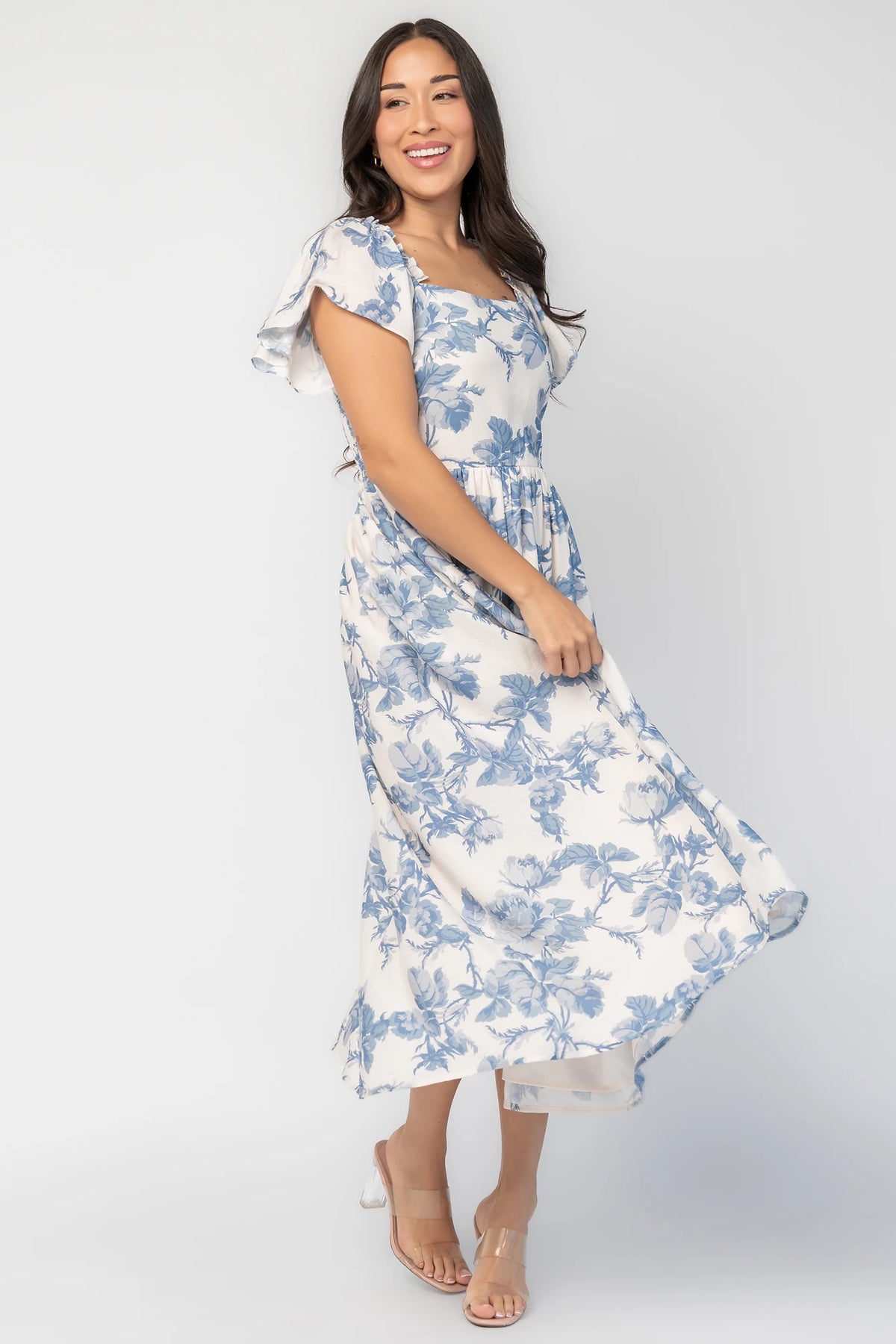 Darlene Dress in Ivory and Blue Floral with square neckline, flutter sleeves, and fit-and-flare midi skirt.