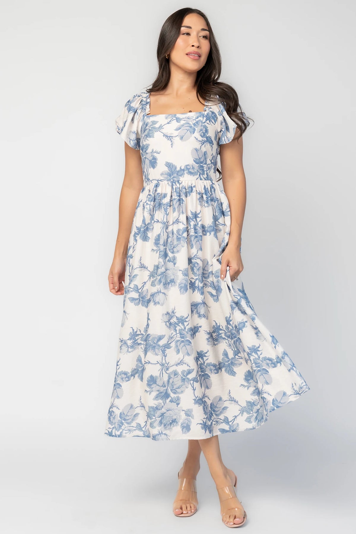 Darlene Dress in Ivory and Blue Floral with square neckline, flutter sleeves, and fit-and-flare midi skirt.