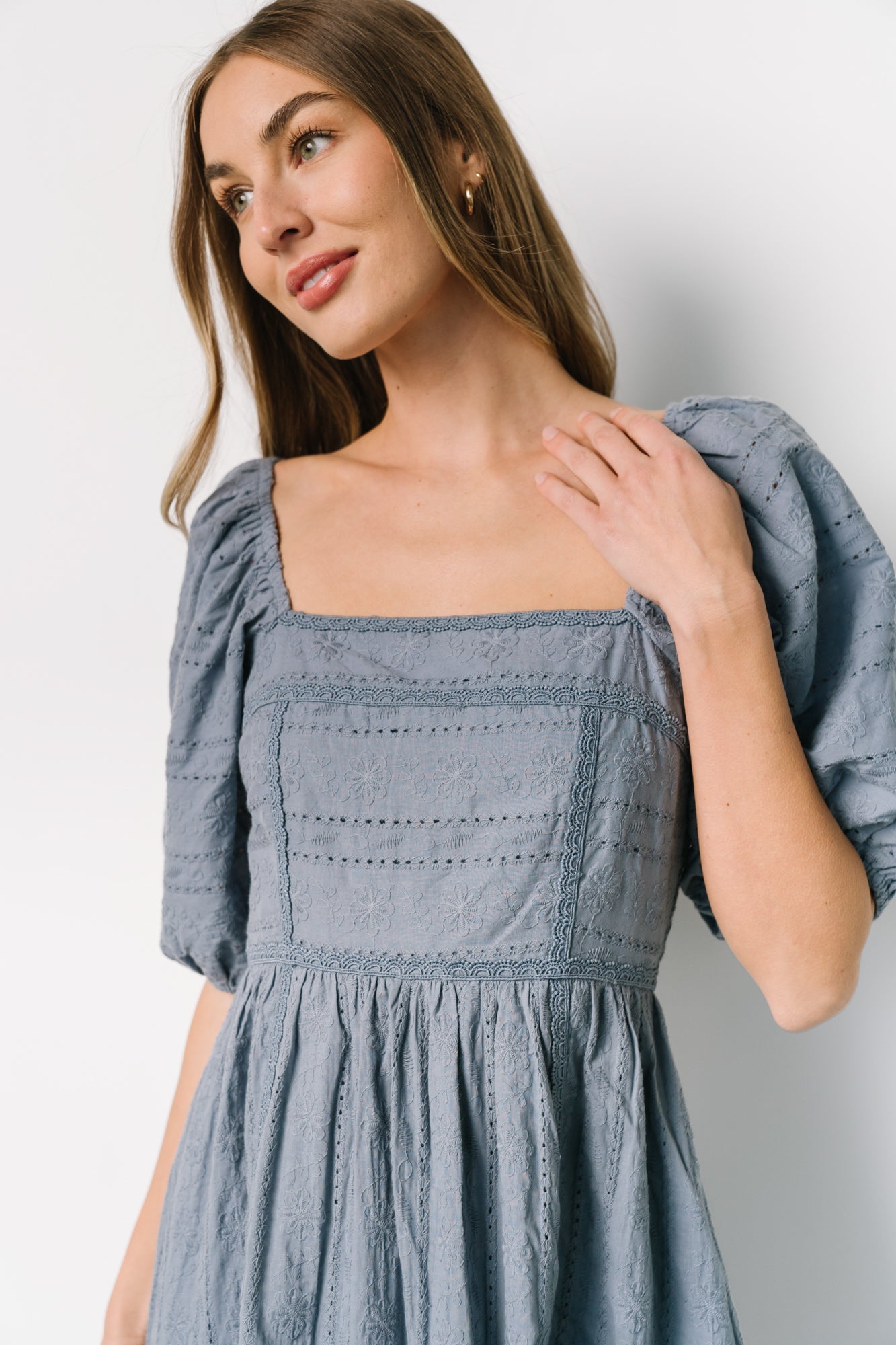 Oversized bubble sleeve detail with elastic cuff on dusty blue Delaney Eyelet dress, showing volume and embroidered stitching.