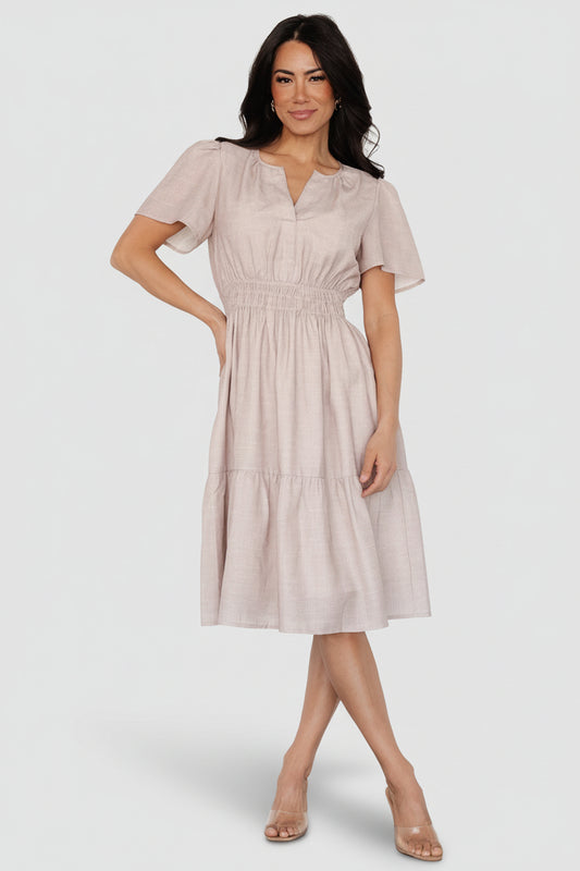 Front view of Dita short dress in natural small-check pattern, showing notched V-neck, smocked elastic waistband, and sheer flutter sleeves for a feminine silhouette.