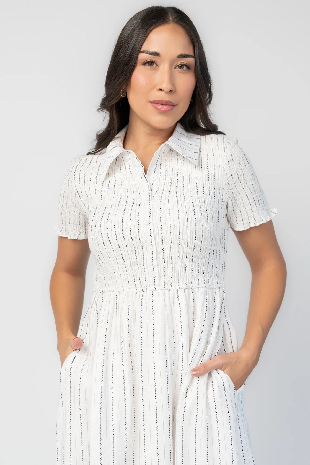 Dottie Striped Midi Dress in Off White with navy vertical stripes, collared neckline, button front, and A-line skirt.