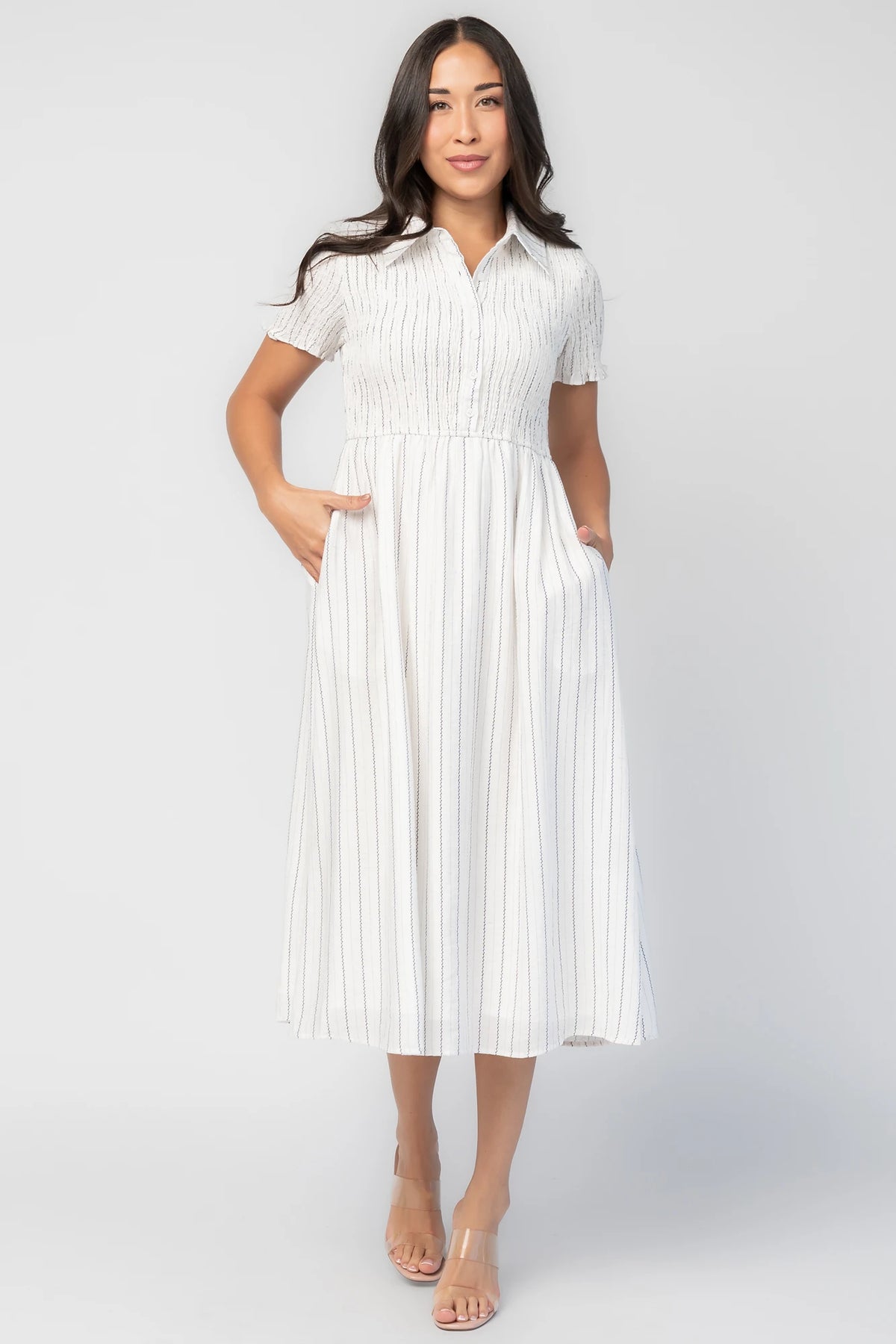 Dottie Striped Midi Dress in Off White with navy vertical stripes, collared neckline, button front, and A-line skirt.