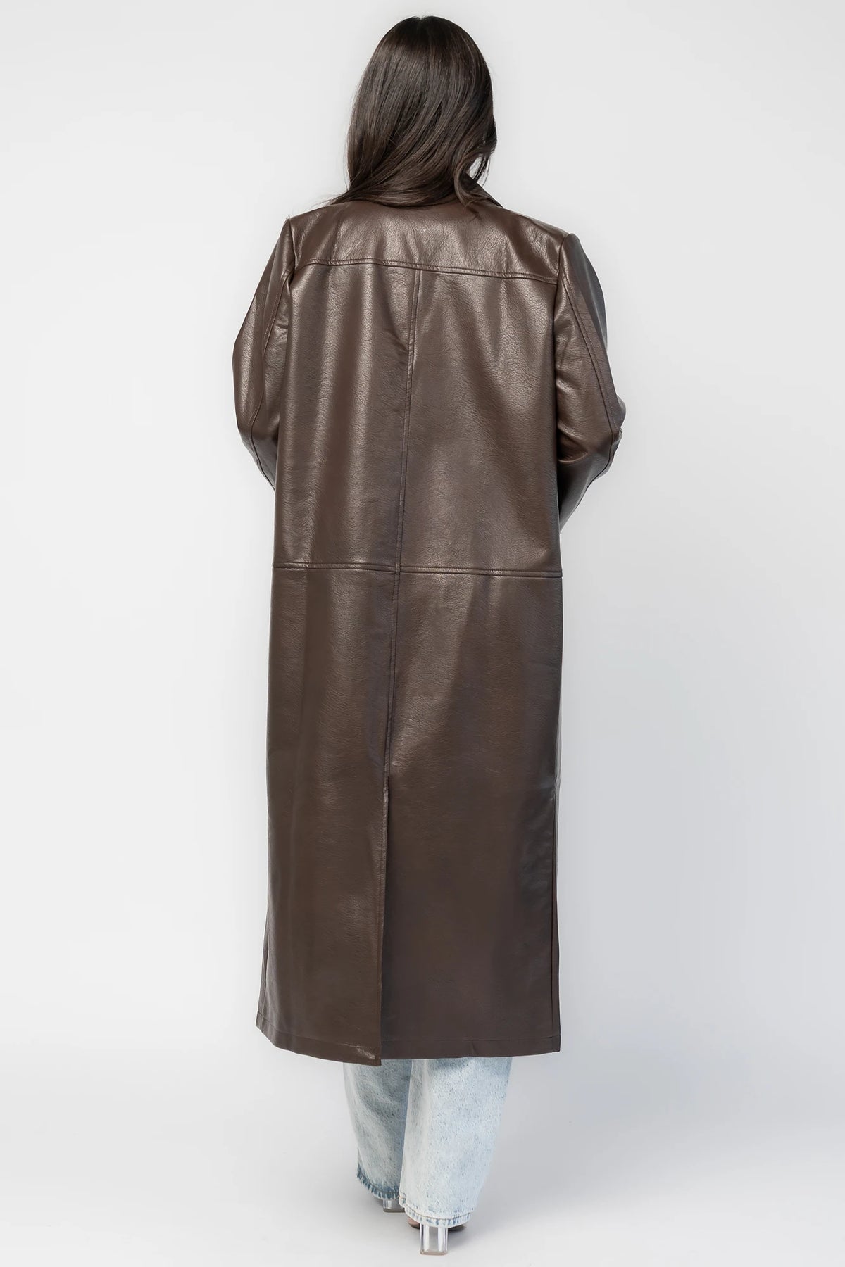 Dove Coat in Brown Faux Leather with notched collar, button front, long sleeves, patch pockets, and longline silhouette.