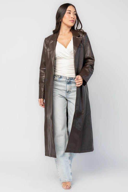 Dove Coat in Brown Faux Leather with notched collar, button front, long sleeves, patch pockets, and longline silhouette.