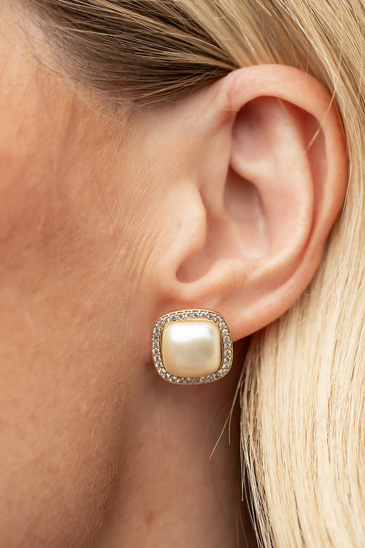 Elianna Pearl Stud Earrings in Gold with square pearl centers, clear stone borders, and polished gold-tone finish.