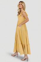 Detail shot of ruffle sleeve and hem with close view of fabric weave and fully lined skirt edge for a finished look.