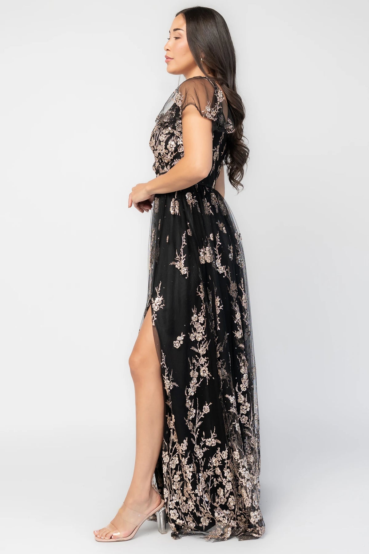 Esmerelda Shimmer Gown in Black + Rose with floral sequin embroidery, surplice V-neckline, flutter sleeves, and front slit.