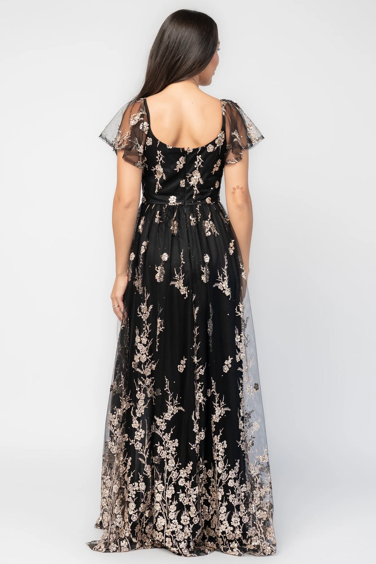 Esmerelda Shimmer Gown in Black + Rose with floral sequin embroidery, surplice V-neckline, flutter sleeves, and front slit.