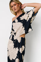 Back and side detail of navy-and-cream maxi highlighting the dramatic sleeve, elasticized waist and unlined fabric drape.