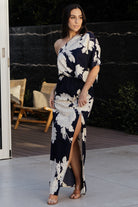 Side view of dress showing left leg slit, flowing maxi skirt and the right-side zipper for a smooth silhouette and movement.