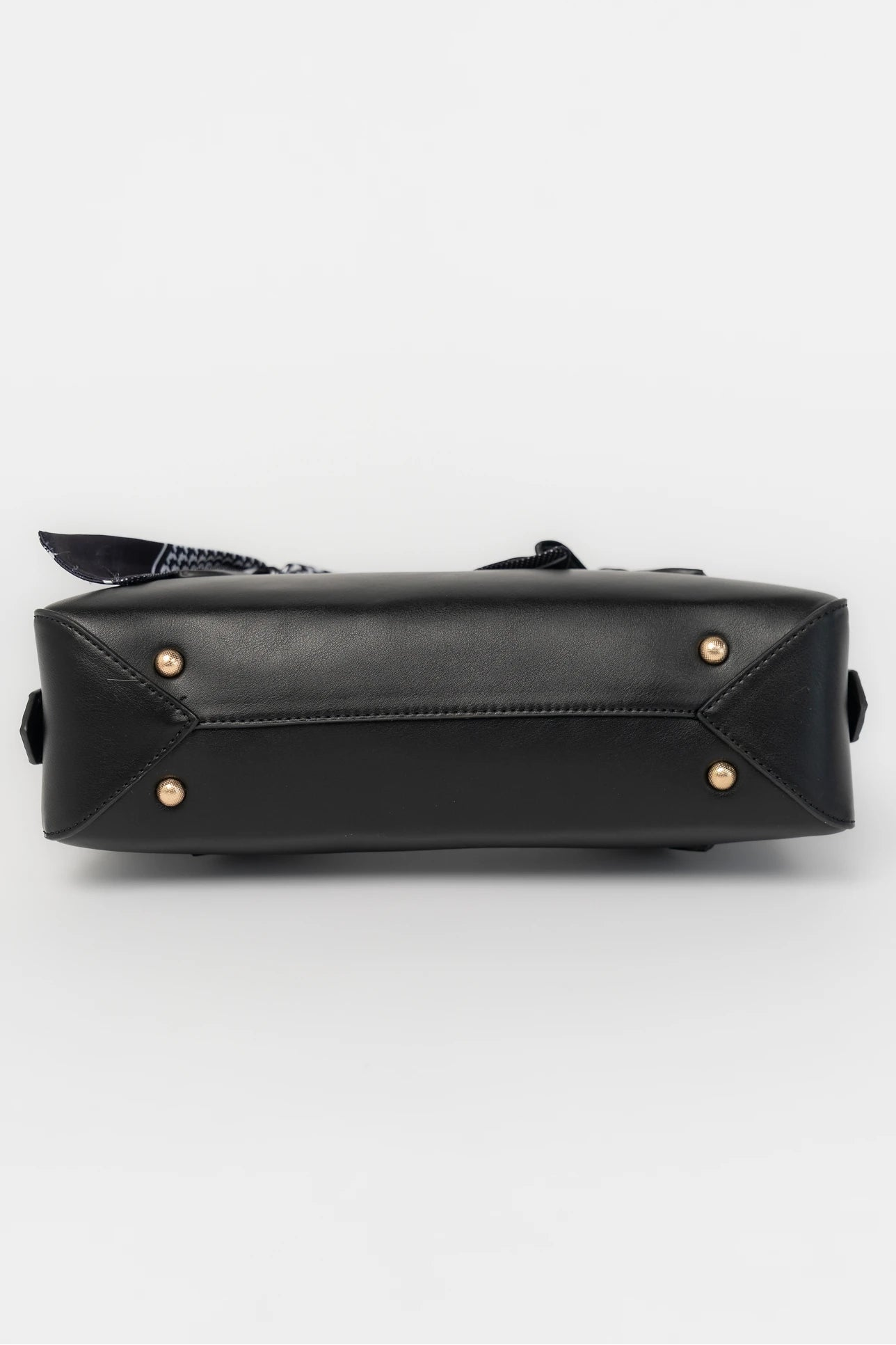 Harmony Mini Shoulder Bag in Black with gold zipper hardware, removable bow, shoulder strap, and interior pockets.