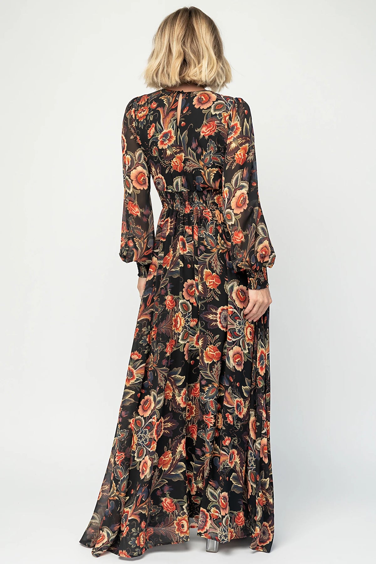 Hera Maxi Dress in Black Multi Print with deep V-neckline, long sleeves, gathered waist, and smocked back.