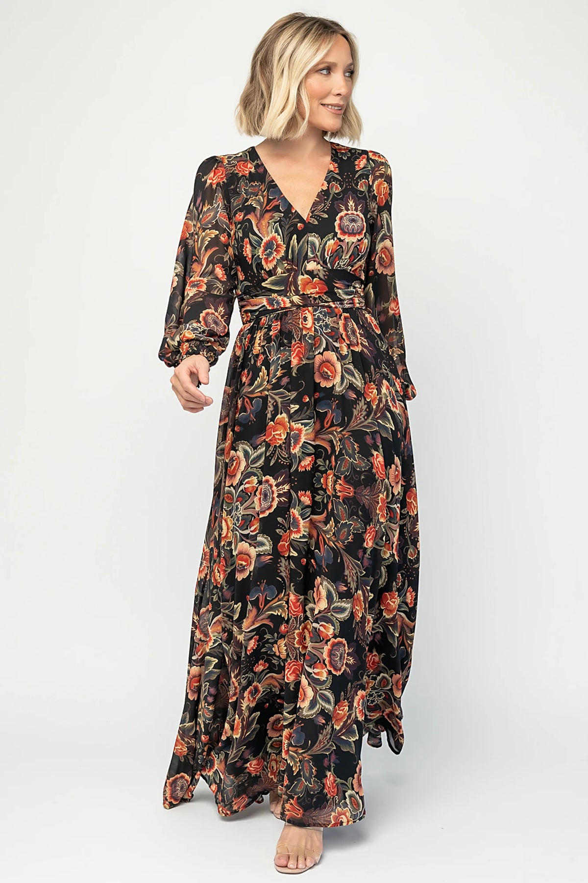 Hera Maxi Dress in Black Multi Print with deep V-neckline, long sleeves, gathered waist, and smocked back.