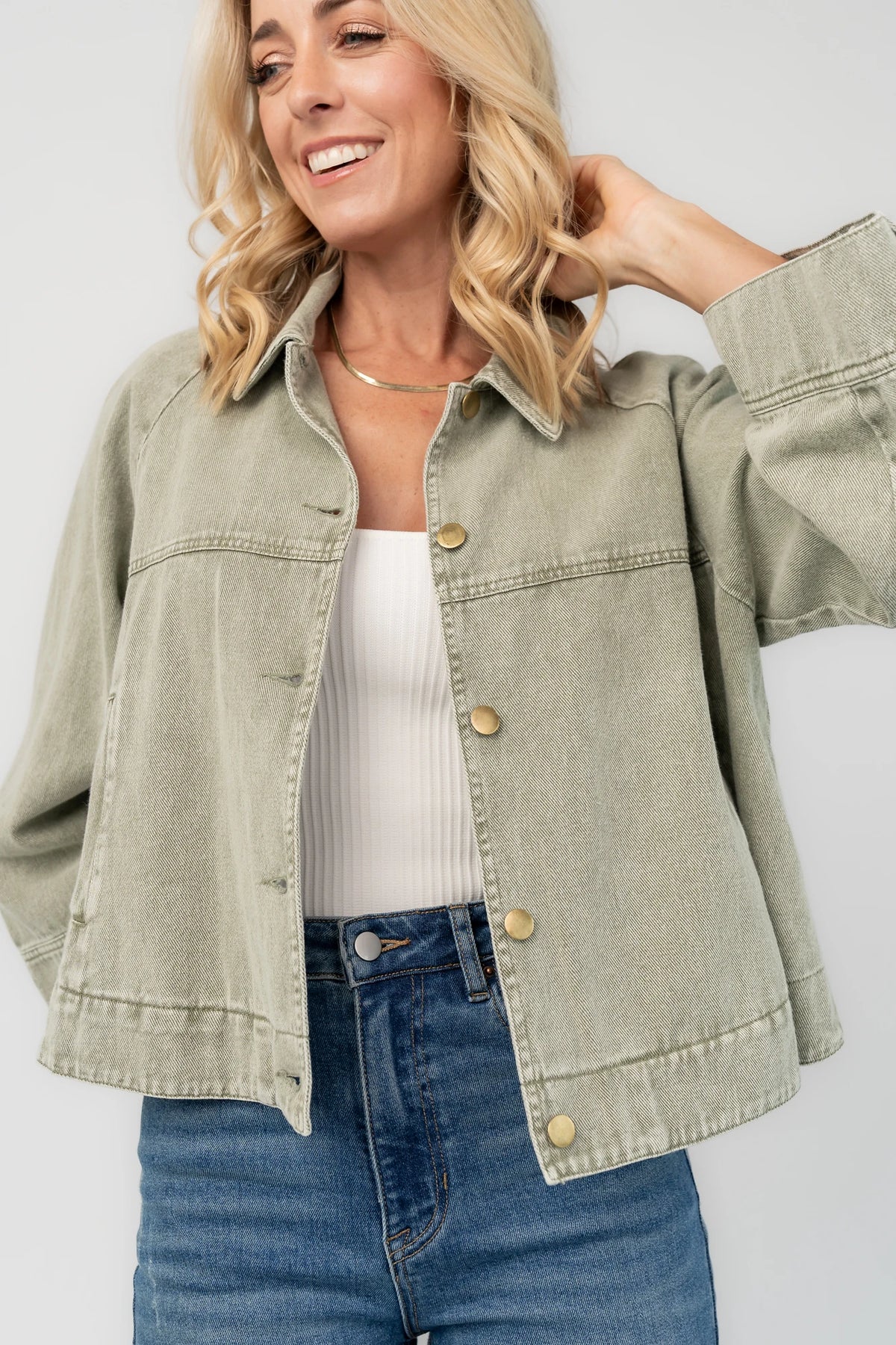 Dusty Olive Cropped Cotton Jacket with collared neckline, button front, raglan sleeves, adjustable cuffs, and side pockets.