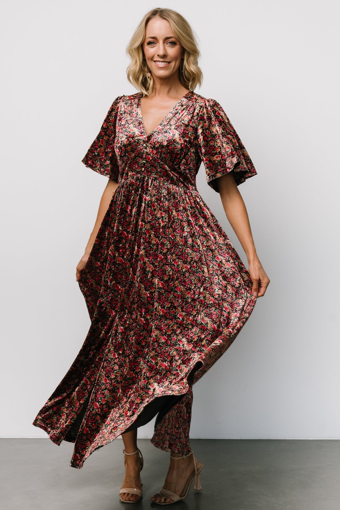 Styled outfit image of the Irina Velvet Maxi Dress in black multi floral paired with heels to show length and overall drape.