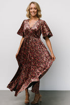 Styled outfit image of the Irina Velvet Maxi Dress in black multi floral paired with heels to show length and overall drape.