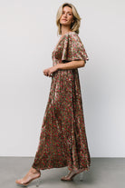 Back view highlighting the smocked empire waist and relaxed straight fit through the body, showing how the dress shapes the silhouette comfortably.