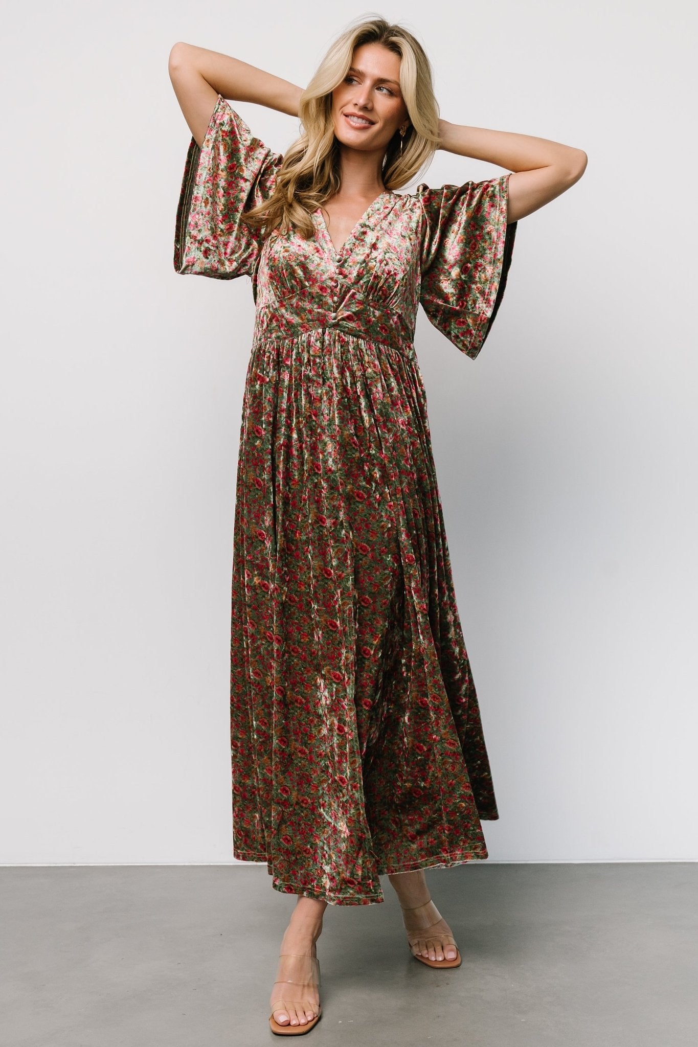 Full-length on-model image showing overall drape, flutter sleeves, empire waist placement and how the partially lined skirt moves with a left slit.