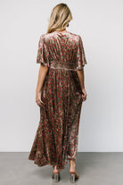 Side view focusing on the hidden left-side zipper and left leg slit, illustrating ease of movement and the dress's flowing maxi skirt.
