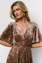 Close-up of bodice detail with faux buttons, gentle gathering at the bust, and subtle gold metallic threads woven into the velvet floral pattern.