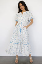 Model wearing the Janie midi dress showing fit with removable sash tied at waist and accessible side pockets.