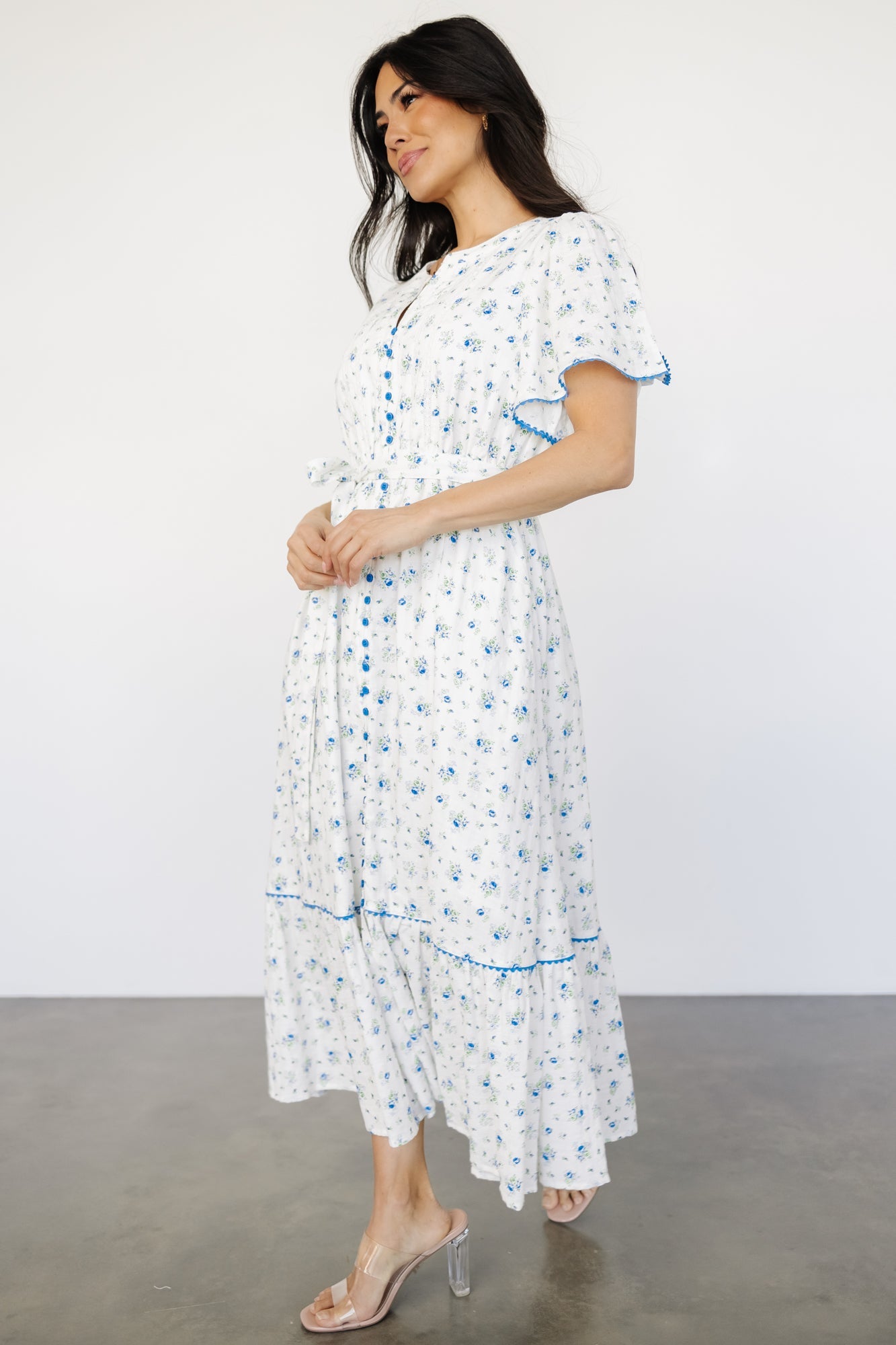 Back and side view of Janie midi dress showing gathered shoulders, short flutter sleeves, and tiered skirt with slit.