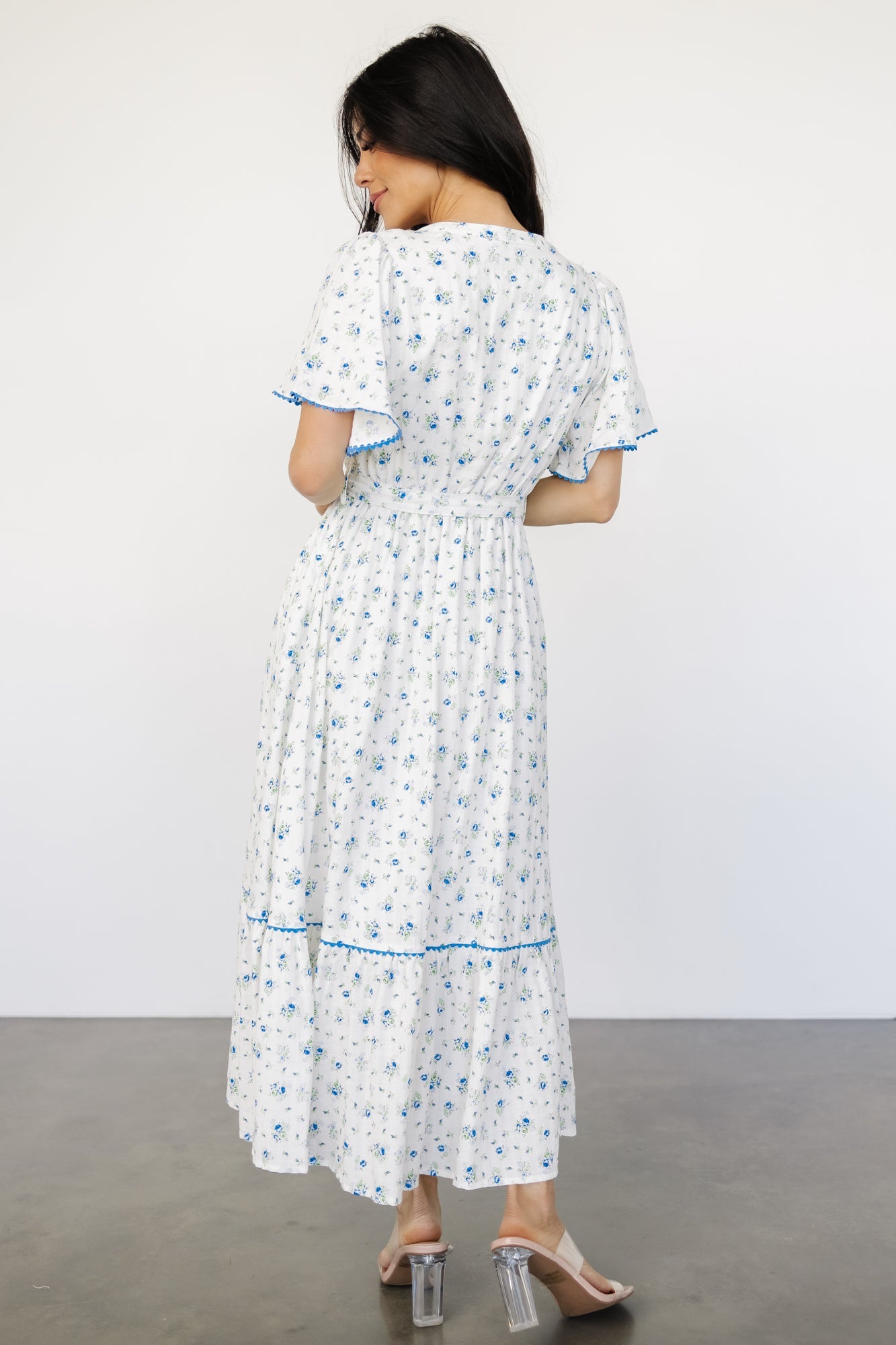Detail image of sleeve cuff and blue scalloped trim, illustrating the short flutter sleeve silhouette and decorative stitching.