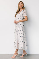Back view of Jesenia midi dress showing elasticized waist and hidden side zipper for a comfortable, adjustable fit.
