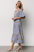 Close-up detail of chiffon fabric and golden floral print on Judith dress, showing fabric darts at the bodice and print scale.