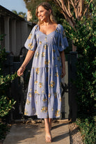Side view of Judith dress showing functional side pockets, tiered midi skirt and gentle drape of the chiffon self fabric.