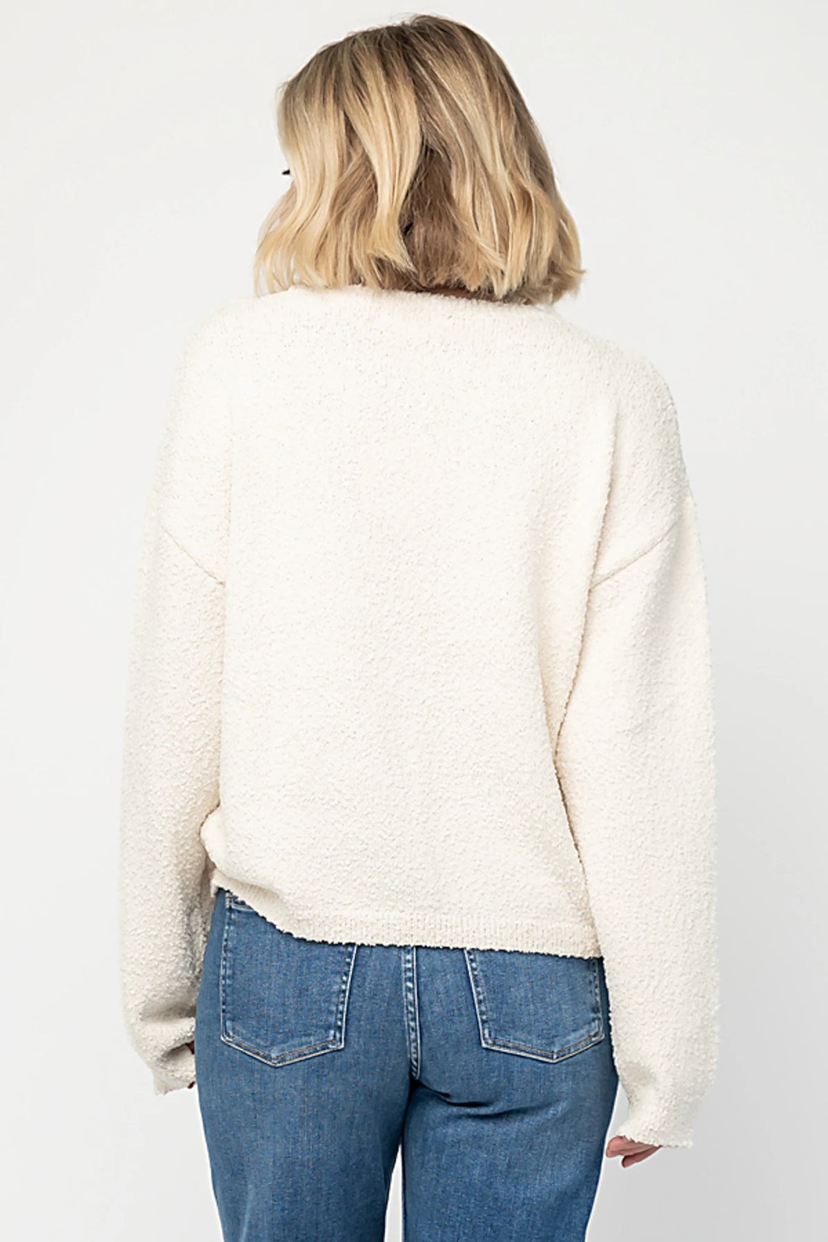 Junie Cozy Bear Sweater in Ivory with teddy bear graphic, red scarf, crew neckline, and ribbed trim.