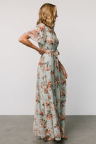 Styled detail of the Katalaya Maxi Dress sash tied at the waist with a flowing maxi skirt and delicate gold floral embroidery on sage tulle.