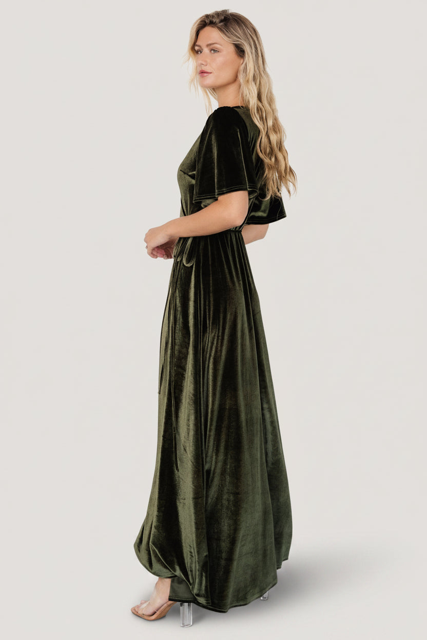 Detail shot of the waist tie loop and self-tie on the Katelyn Velvet Maxi Wrap Dress in dark olive, showing construction and secure fit.