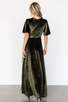 Close-up of the V-neck and bodice of the Katelyn Velvet Maxi Wrap Dress in dark olive, illustrating neckline coverage and fabric finish.