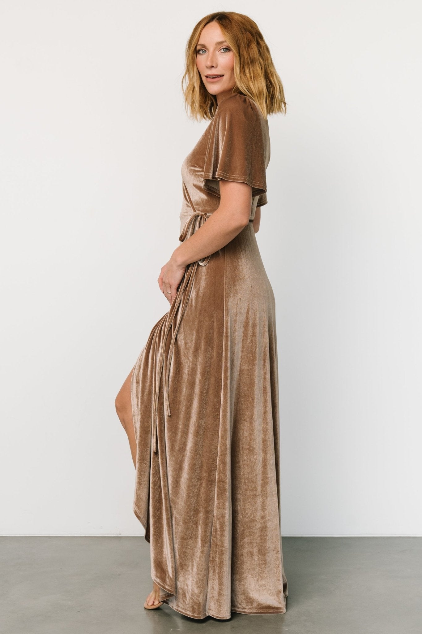 Close-up of taupe velvet fabric and V-neckline on the Katelyn Maxi Wrap Dress, showing texture and subtle stretch of material.