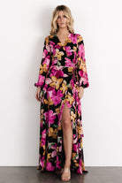 Three-quarter front shot of the Katinka Wrap Maxi Dress, highlighting the floral print, bishop sleeves with elastic cuffs, and the adjustable self-tie waist.