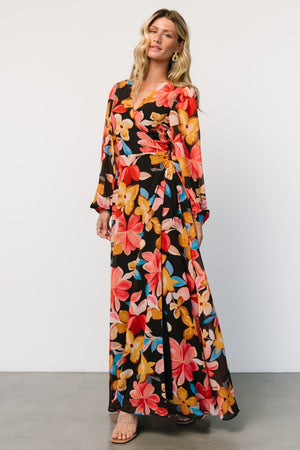 Front view of Katinka Wrap Maxi Dress in Tropical Night Floral; chiffon skirt, surplice neckline, waist tie and flowing hem.