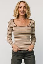 Front view of model wearing Kaylee taupe stripe long sleeve fitted knit top, showing wide rounded-square neckline and slim, body-skimming silhouette.