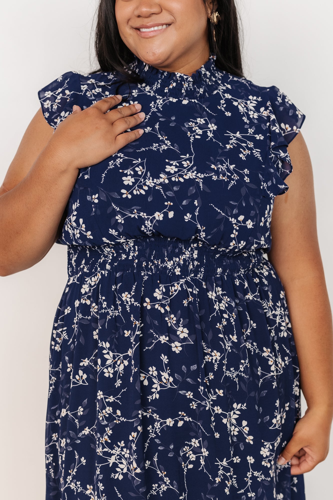 Model walking in blue floral chiffon maxi dress, illustrating airy drape, ruffle hem motion, and the flattering smocked waistline.