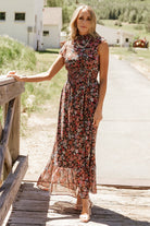 Model wearing the Kearny Ruffle Maxi Dress in a styled look, paired with minimal accessories to showcase silhouette and movement.