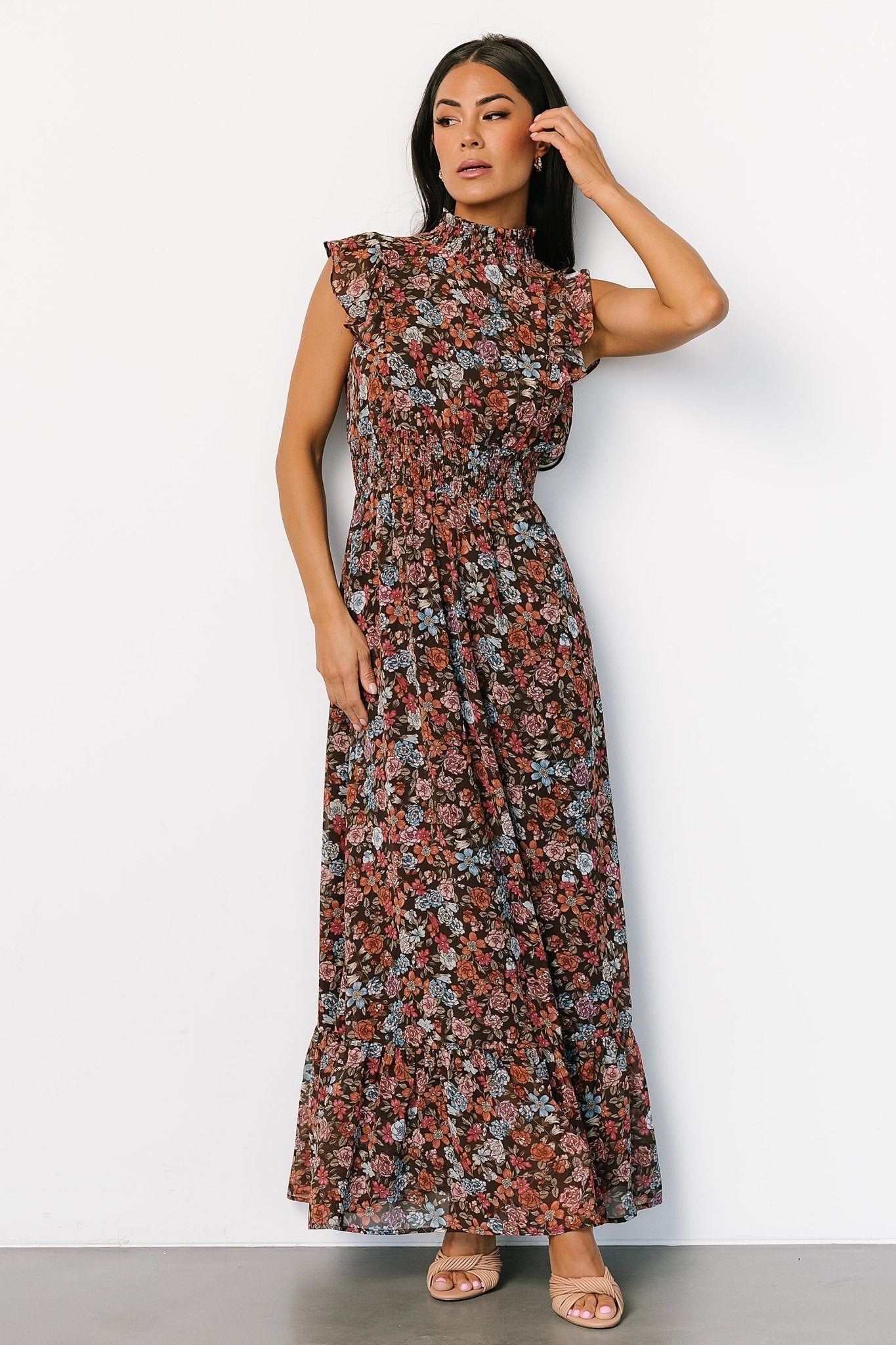 Full-length shot of the brown multi floral Kearny Ruffle Maxi Dress, highlighting ruffle hem, smocked waist, and elegant silhouette.
