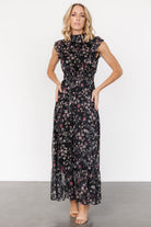 Front view of the Kearny Ruffle Maxi Dress in midnight with gold floral print, showing smocked high neckline and flowing chiffon skirt.