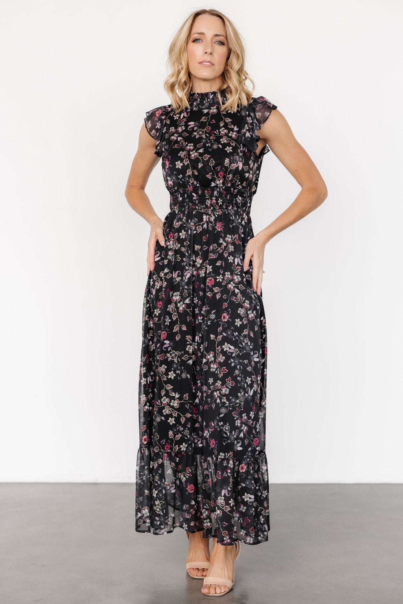 Front view of the Kearny Ruffle Maxi Dress in midnight with gold floral print, showing smocked high neckline and flowing chiffon skirt.